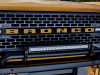 2021-ford-bronco-2-door-cyber-orange-metallic-tri-coat-exterior-018-front-grille-detail-tow-hooks-headlights-light-bar