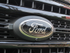 2020-ford-f-250-super-duty-lariat-with-sport-package-and-tremor-package-exterior-003-black-ford-badge-logo