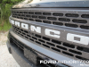 2021-ford-bronco-sport-badlands-fa-garage-exterior-025-bronco-logo-badge-on-grille