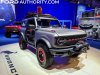 2021-ford-bronco-off-road-wheeling-and-beyond-two-door-concept-2021-sema-live-photos-exterior-002-front-three-quarters-grille-red-letters-warn-winch-ford-modular-bumper-tube-doors-yakima-roof-rack