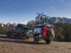 2021-ford-explorer-timberline-exterior-017-rear-three-quarters-off-road-towing-campign-trailer-with-bikes-loaded-roof-rack