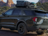 2021-ford-explorer-timberline-exterior-020-rear-three-quarters-off-road-towing-campign-trailer-with-bikes-loaded-roof-rack