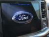 2021-ford-f-150-king-ranch-interior-front-row-022-infotainment-screen-with-ford-logo