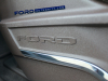 2021-ford-f-150-king-ranch-interior-front-row-040-ford-logo-on-front-passenger-seat-base