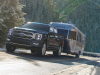 2021-ford-f-150-limited-exterior-028-front-three-quarters-towing-airstream-trailer