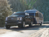 2021-ford-f-150-limited-exterior-029-front-three-quarters-towing-airstream-trailer