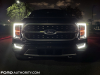 2021-ford-f-150-platinum-powerboost-fa-garage-night-exterior-002-front-headlights-drls