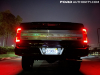 2021-ford-f-150-platinum-powerboost-fa-garage-night-exterior-018-rear-tail-lights-platinum-deboss-logo-on-tailgate