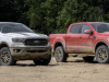 2021-ford-ranger-tremor-xlt-and-lariat-exterior-001-front-three-quarters-standing-still-in-dirt-and-sand