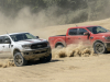 2021-ford-ranger-tremor-xlt-and-lariat-exterior-002-front-three-quarters-standing-still-in-dirt-and-sand-kicking-up-dirt
