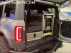 ford-bronco-all-female-build-sema-2022-live-photos-exterior-013-rear-tail-light-cargo-area-trunk-with-gear
