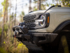 2022-ford-bronco-everglades-desert-sand-color-press-photos-exterior-058-front-end-warn-winch-carbonized-gray-grille-headlights-carbonized-gray-grille