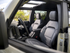 2022-ford-bronco-everglades-interior-004-marine-grade-vinyl-front-seats-with-bronco-logo-steering-wheel-grab-handle