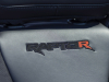 2023-ford-f-150-raptor-r-press-photos-interior-005-raptor-r-logo-with-code-orange-accent-on-front-seatback