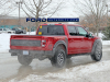 2021-ford-f-150-raptor-35-inch-tire-graphics-package-live-photos-012-rear-three-quarters-box-decals-raptor-script-fp-ford-performance-gn-generation-03-usa-flag-ford-script-on-tailgate
