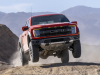 2021-ford-f-150-raptor-exterior-084-code-orange-raptor-37-performance-package-front-three-quarters-jumping