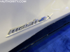 2022-ford-mustang-mach-e-ice-white-appearance-package-2022-nyias-live-photos-exterior-017-mach-e4x-logo-badge-on-front-door