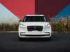 2022-lincoln-aviator-jet-appearance-package-manufacturer-photos-exterior-001-pristine-white-front-headlamps-grille-lincoln-logo