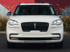 2022-lincoln-aviator-jet-appearance-package-manufacturer-photos-exterior-003-pristine-white-front-headlamps-grille-lincoln-logo