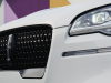 2022-lincoln-aviator-jet-appearance-package-manufacturer-photos-exterior-012-pristine-white-pristine-white-front-detail-headlamp-grille-lincoln-logo