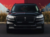 2022-lincoln-aviator-jet-appearance-package-manufacturer-photos-exterior-020-infinite-black-front-headlamps-grille-lincoln-logo