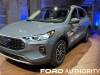 2023-ford-escape-phev-vapor-blue-k1-live-photos-exterior-004-side-front-three-quarters-plugged-in-charging