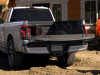 2022-ford-f-150-lightning-lariat-exterior-018-rear-three-quarters-tailgate-down-construction-site