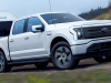 2022-ford-f-150-lightning-lariat-exterior-022-front-three-quarters-towing-trailer
