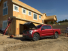 2022-ford-f-150-lightning-lariat-exterior-023-front-three-quarters-construction-site-frunk-open