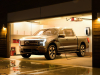 2022-ford-f-150-lightning-platinum-exterior-008-front-three-quarters-in-garage-after-storm