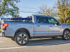 2022-ford-f-150-lightning-platinum-iconic-silver-first-on-the-road-photos-october-2021-exterior-008-side-lightning-logo-badge