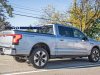 2022-ford-f-150-lightning-platinum-iconic-silver-first-on-the-road-photos-october-2021-exterior-009-rear-three-quarters-lightning-logo-badge