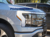 2022-ford-f-150-lightning-platinum-iconic-silver-first-on-the-road-photos-october-2021-exterior-016-front-end-headlight-light-bar-grille