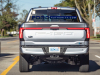 2022-ford-f-150-lightning-platinum-iconic-silver-first-on-the-road-photos-october-2021-exterior-018-rear-tailgate-tail-lights-light-bar-f-150-debossed-logo-us-flag-ford-logo-badge