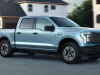 2022-ford-f-150-lightning-pro-exterior-012-front-three-quarters-towing-trailer-with-bobcat