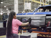 2022-ford-f-150-lightning-start-of-production-rouge-electric-vehicle-center-april-26-2022-010-shemika-winston-installing-grille-with-ford-logo