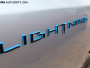 2022-ford-f150-lightning-platinum-first-drive-exterior-013-lightning-logo-badge