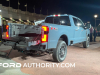 2023-ford-f-series-super-duty-f-250-lariat-azure-gray-reveal-event-october-2022-exterior-007-rear-three-quarters-rear-bumper-step-tail-lights-on-integrated-tail-gate-step-ladder-extending-grab-handle