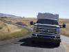 2023-ford-super-duty-f-350-drw-dually-lariat-press-photos-exterior-001-front-towing-trailer