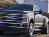 2023-ford-super-duty-f-350-drw-dually-lariat-press-photos-exterior-005-front-three-quarters-towing-trailer