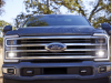 2023-ford-super-duty-f-350-limited-press-photos-exterior-001-front-hood-superduty-script-drl-daytime-running-lights-grille-ford-logo-badge-tow-hooks-fog-lights