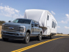2023-ford-super-duty-f-350-limited-press-photos-exterior-005-front-three-quarters-towing-trailer