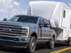 2023-ford-super-duty-f-350-limited-press-photos-exterior-006-front-three-quarters-towing-trailer