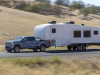 2023-ford-super-duty-f-350-limited-press-photos-exterior-007-side-front-three-quarters-towing-trailer