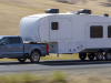 2023-ford-super-duty-f-350-limited-press-photos-exterior-008-side-front-three-quarters-towing-trailer