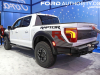 2024-ford-f-150-raptor-r-2023-naias-oxford-white-yz-exterior-004-rear-three-quarters-red-rear-side-marker-light-tail-light-tailgate-exhaust