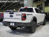 2024-ford-ranger-raptor-oxford-white-yz-2023-naias-exterior-003-rear-three-quarters-tail-lights-tailgate-dual-exhaust
