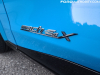 2021-ford-mustang-mach-e-first-edition-grabber-blue-fa-garage-exterior-011-mach-e-4x-logo-badge-on-front-door