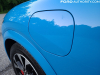 2021-ford-mustang-mach-e-first-edition-grabber-blue-fa-garage-exterior-021-charge-port-door-closed