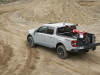 2023-ford-maverick-tremor-press-photos-exterior-015-off-road-rear-three-quarters-dirt-bike-loaded-into-bed-tailgate-adjusted-position